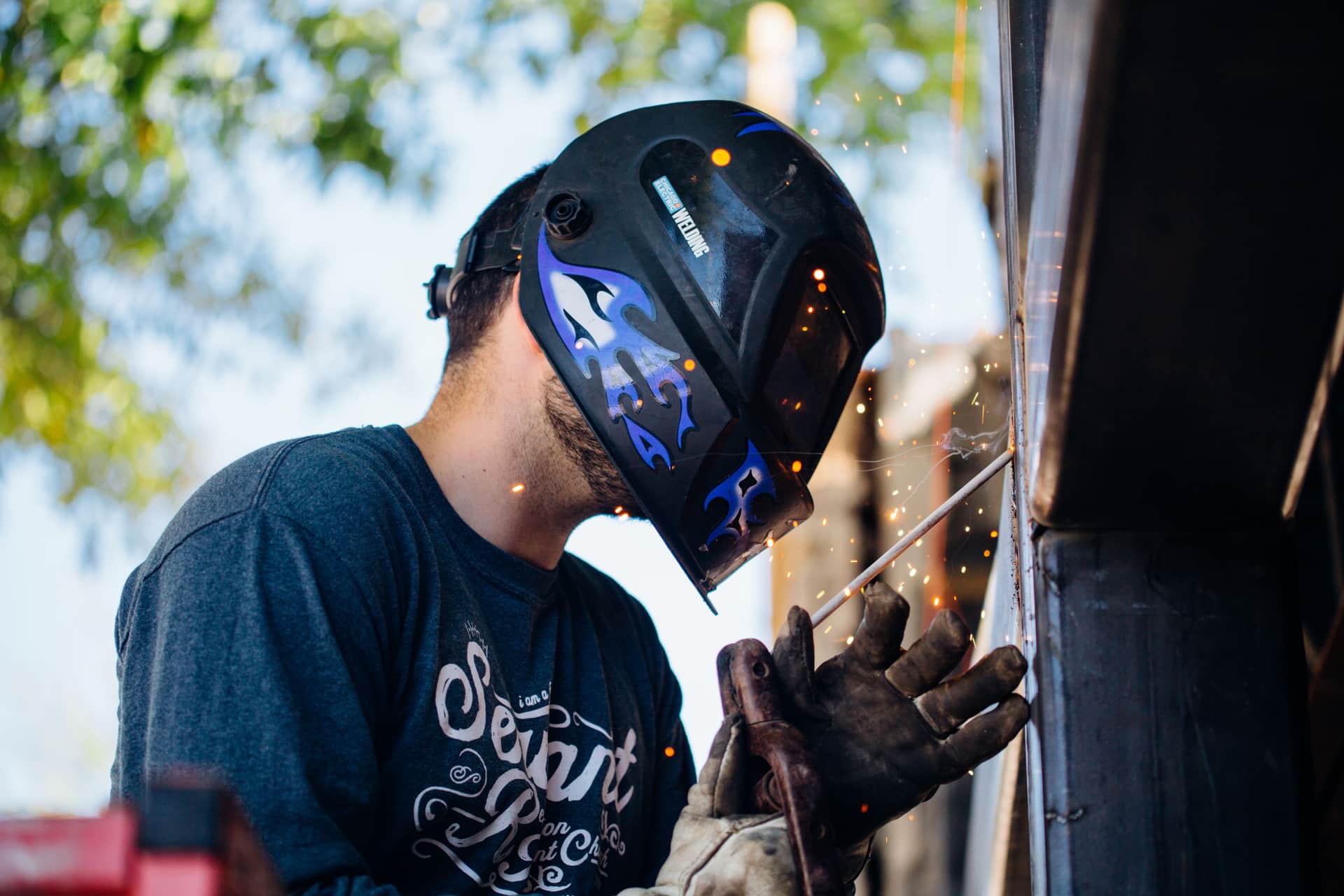 An entry-level auto-darkening welding helmet with the lens facing upward on a bench